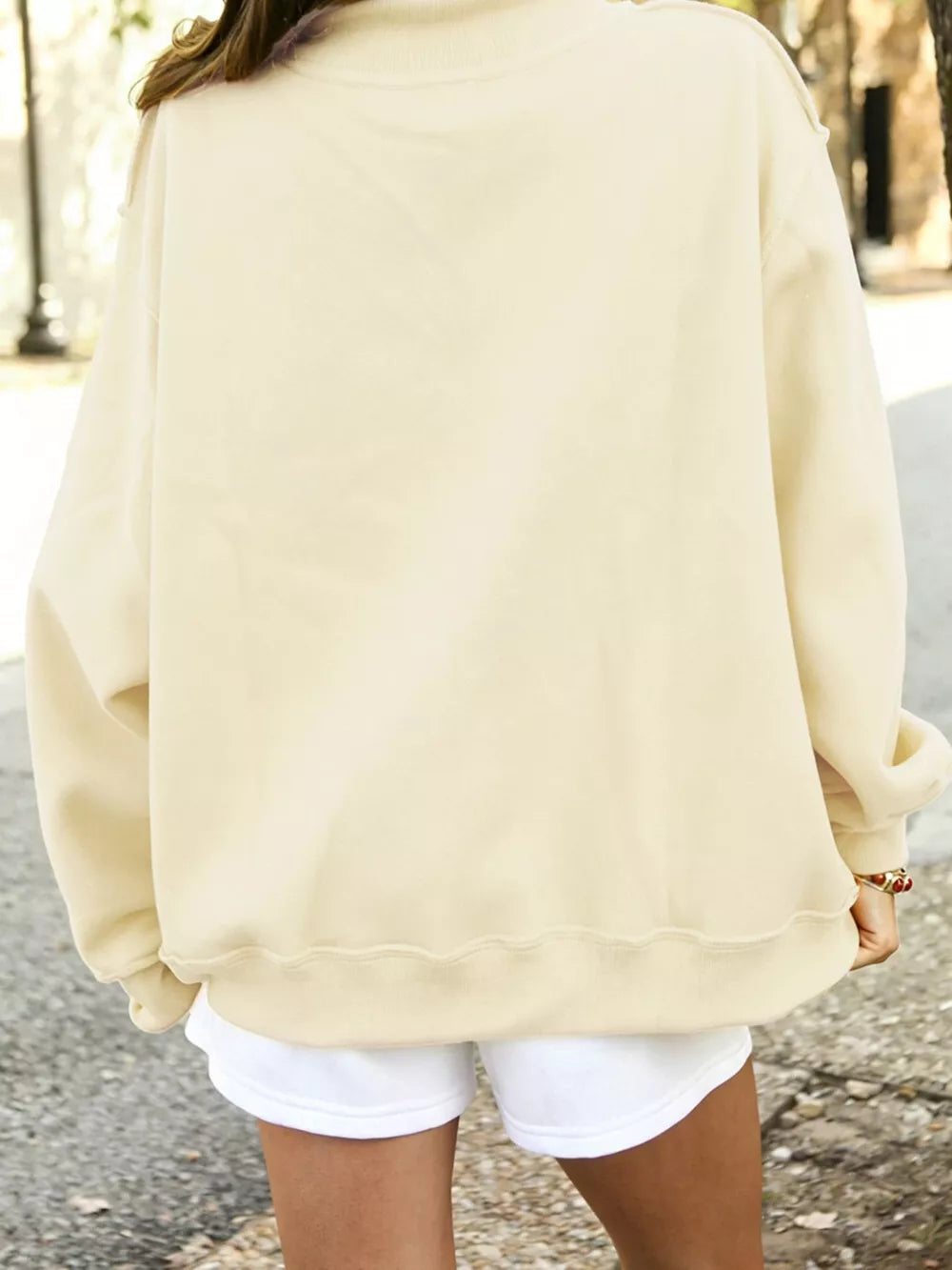 sweatshirt in Blush Pink with exposed seam and hip-length