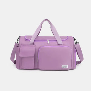 Purple canvas weekender bag with multiple utility pockets and adjustable strap