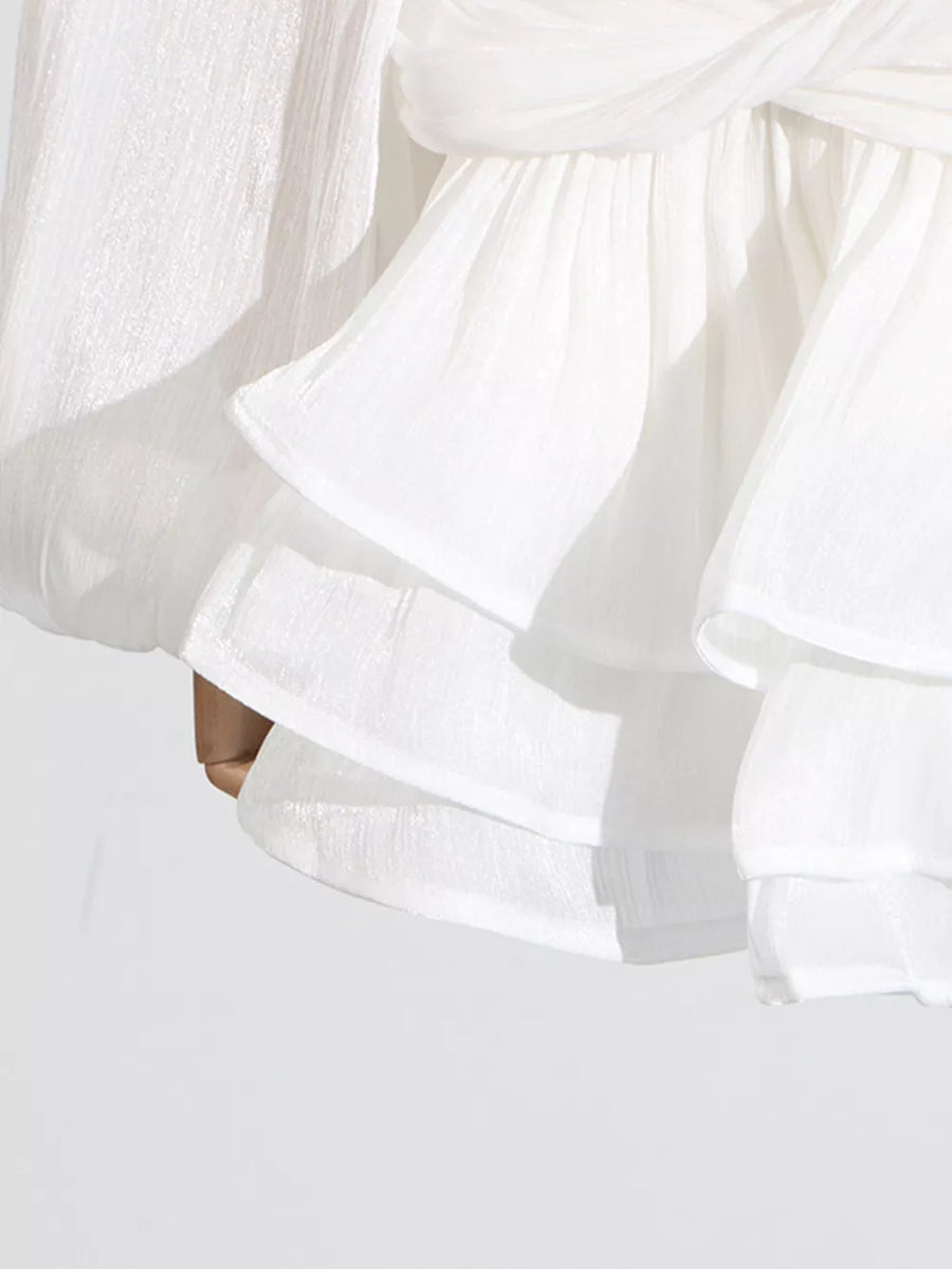 White ruffle mini dress with balloon sleeves and a twisted detail.