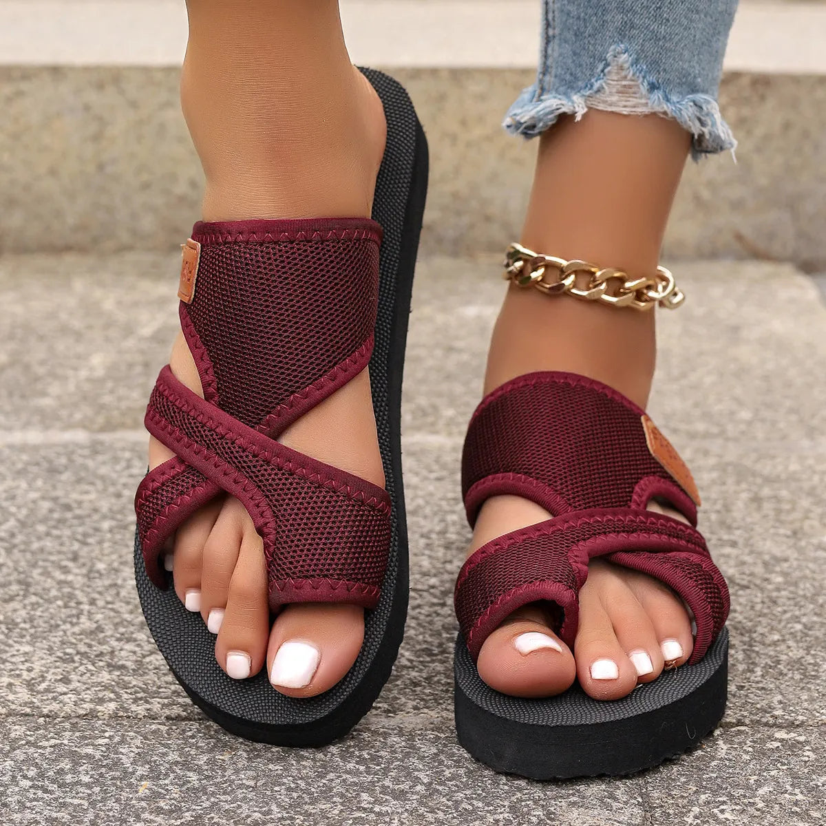 Cross-strap sporty slides in deep purple with a textured sole and branding detail.