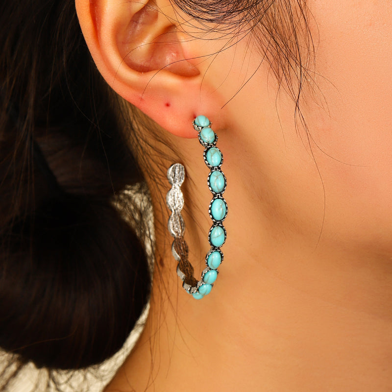 Textured turquoise stone hoop earrings with silver-tone metal and oval stones.