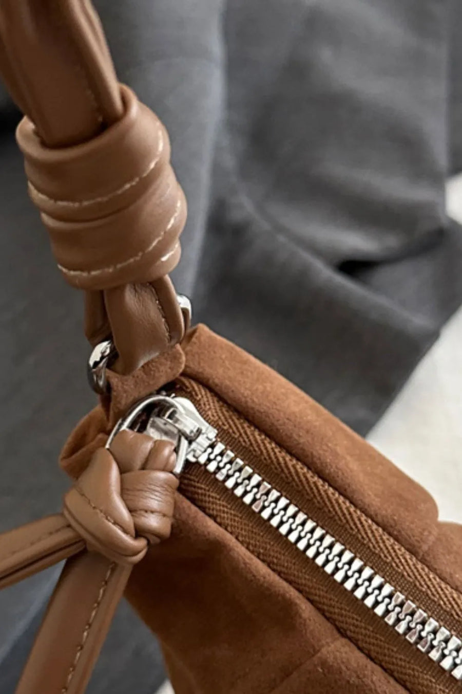 Brown suede shoulder bag with knot detail and silver zipper