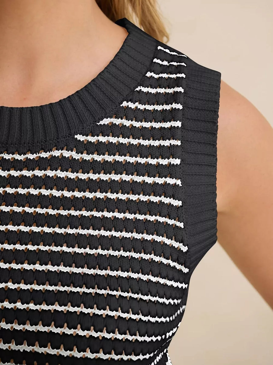 Black knit sweater vest with white horizontal stripes and textured details.