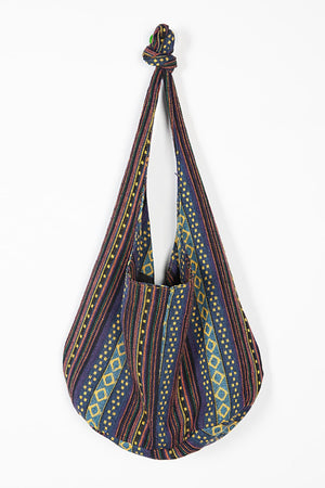 Tribal weave shoulder bag with geometric patterns in multicolor canvas.