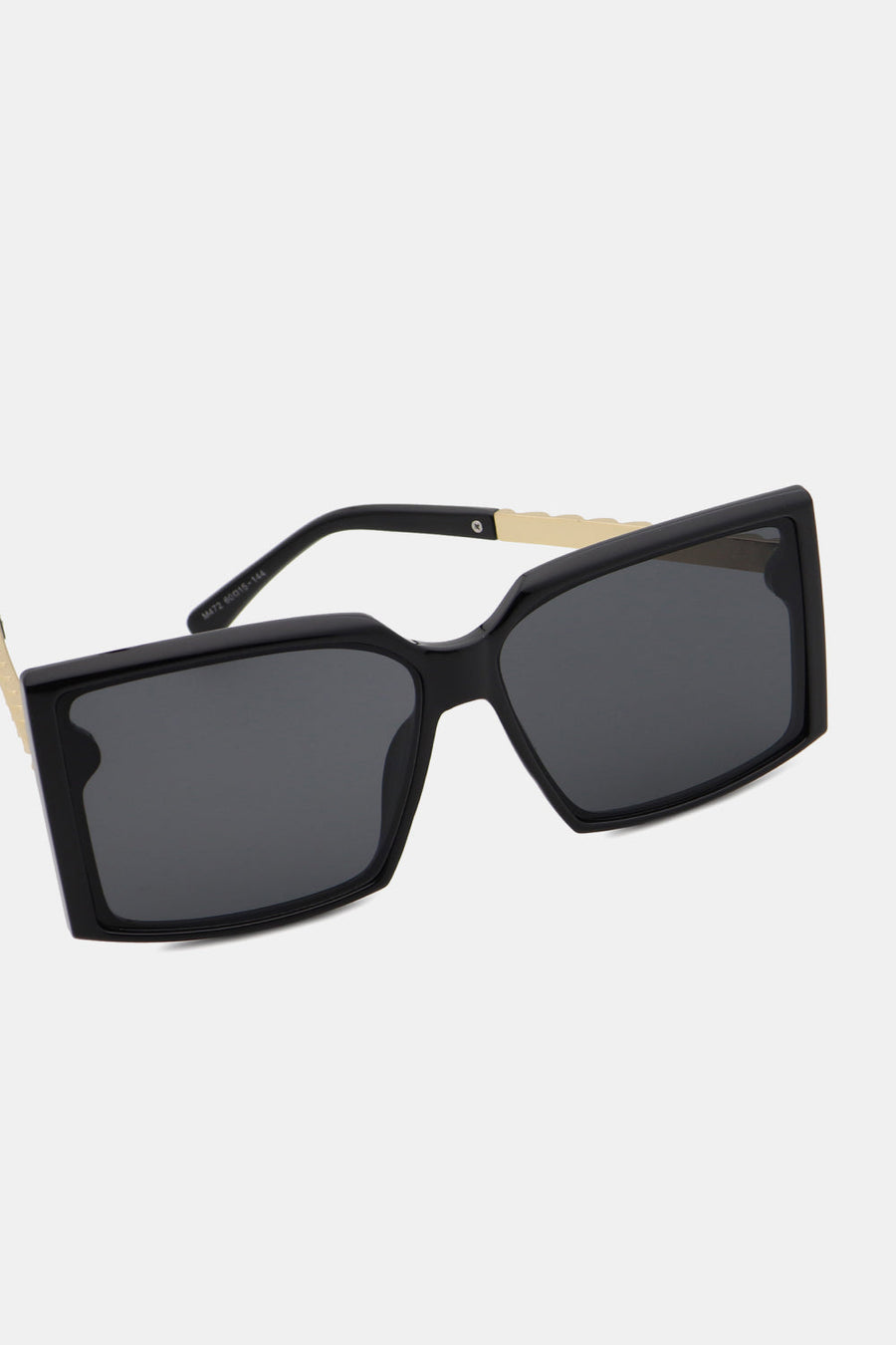 Black geometric sunglasses with gradient lenses and gold temple accents.