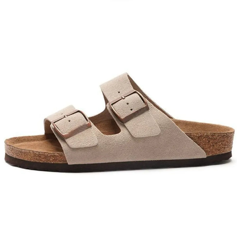 Beige suede Arizona-inspired slide sandals with adjustable buckles and cork sole.