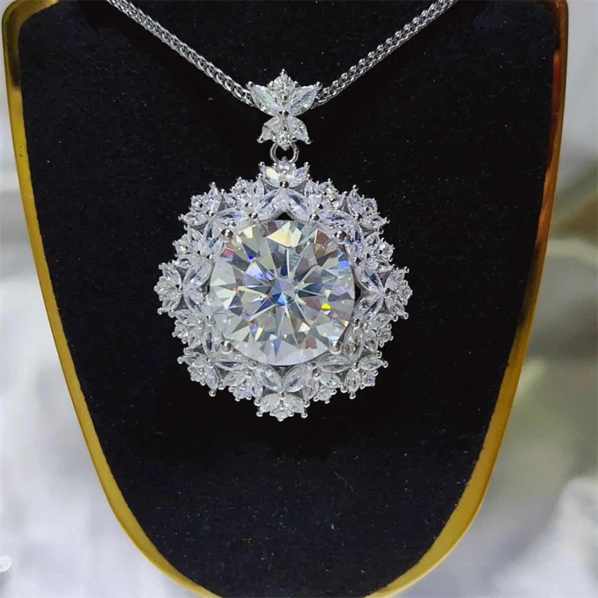 Radiant Cluster Pendant Necklace in white, featuring a large central stone surrounded by floral-shaped crystals.