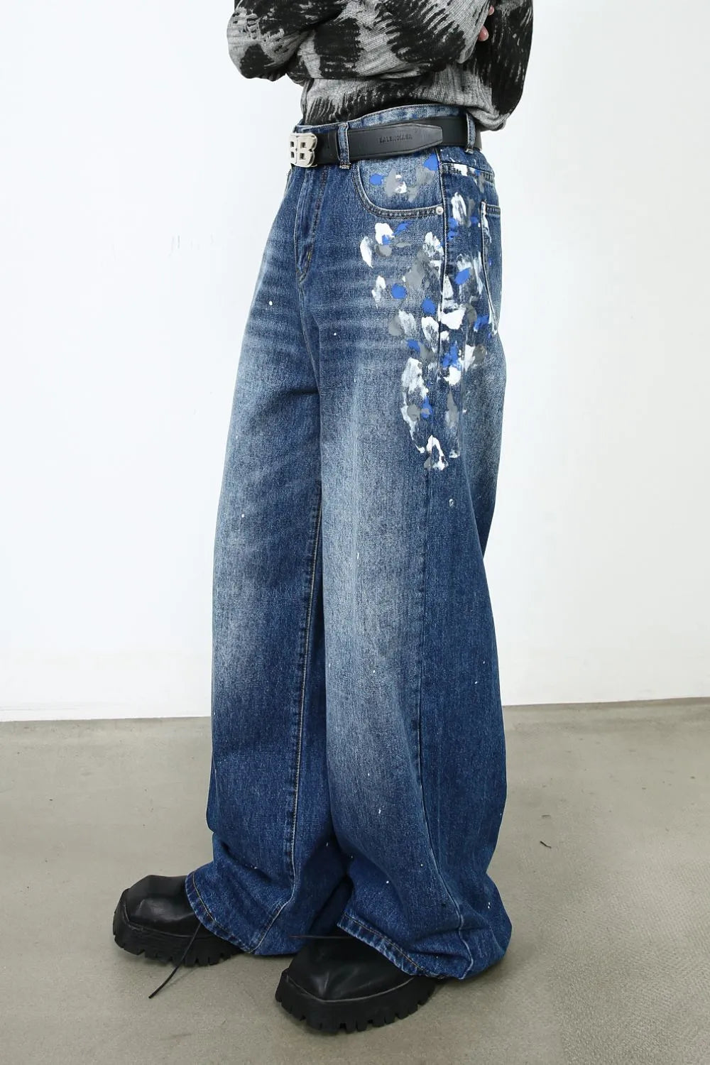 Painterly denim palazzo trousers in medium wash with blue and white paint splatters.