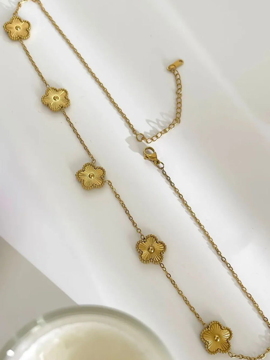 necklace in gold with floral and delicate floral charms