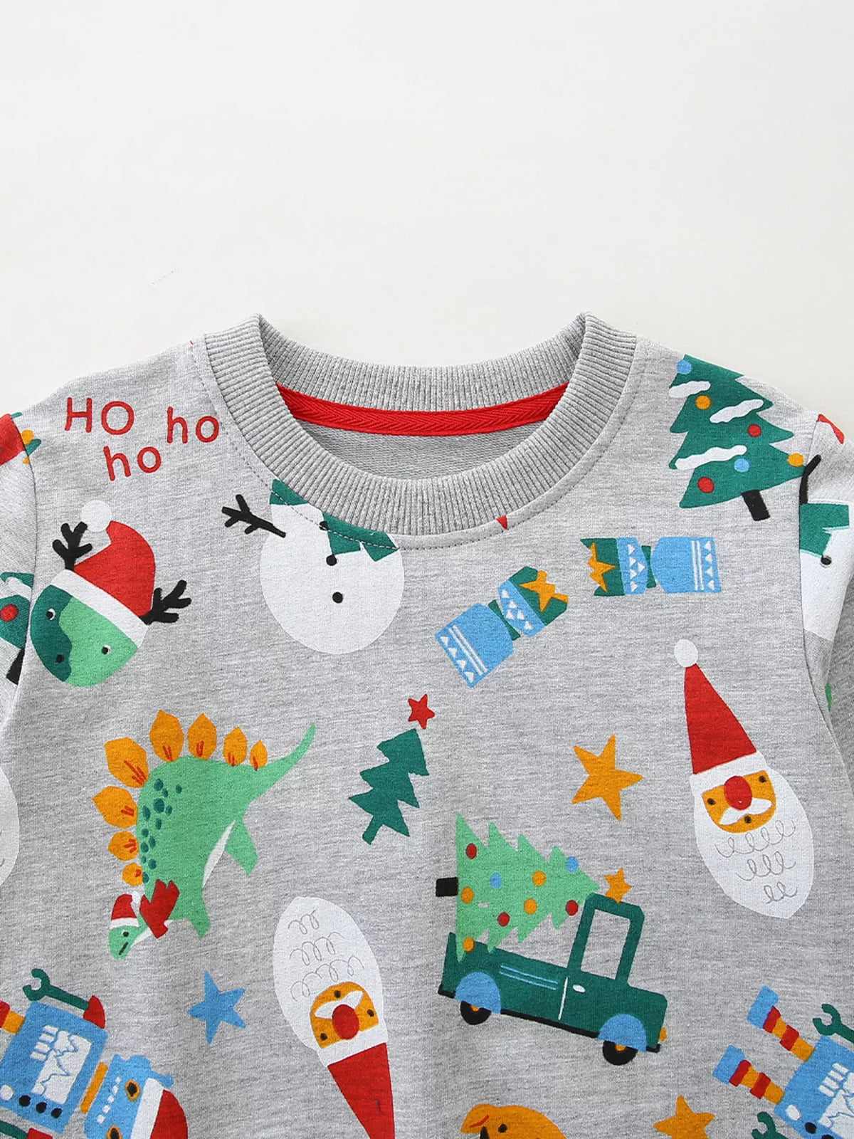 Gray crewneck sweatshirt with festive Christmas print including Santa, snowmen, dinosaurs, and trees.