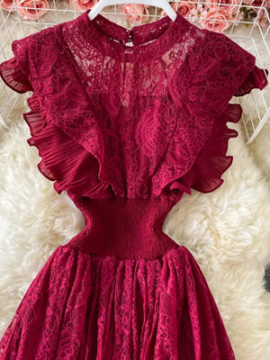 Red lace maxi dress with ruffled sleeves and smocked waist detail.