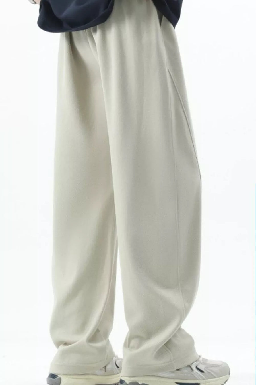 Men's beige loose fit sweatpants with a relaxed cut and side seam detail.