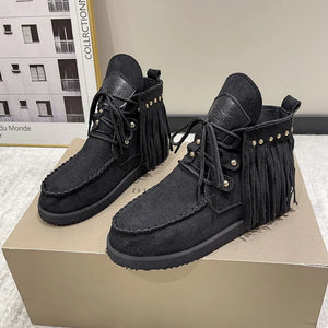 Black fringed moc-toe ankle boots with lace-up closure and stud details.