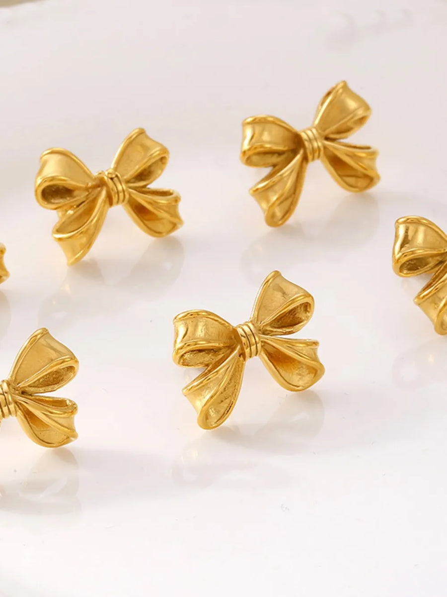 Gold bow earrings with pearl accents, 18K gold plated, chic jewelry set for women.