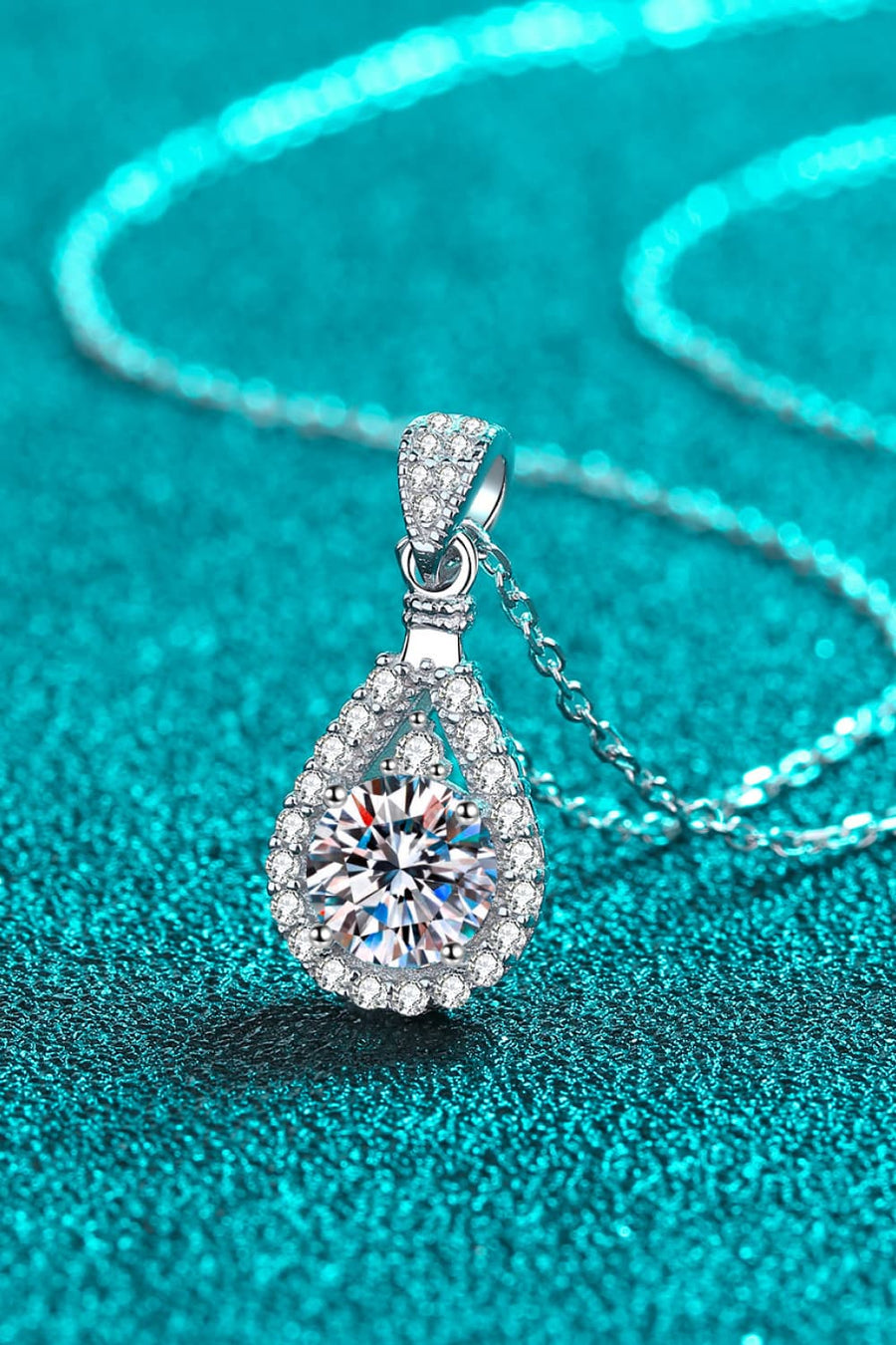 Sterling silver necklace with a halo moissanite teardrop pendant.