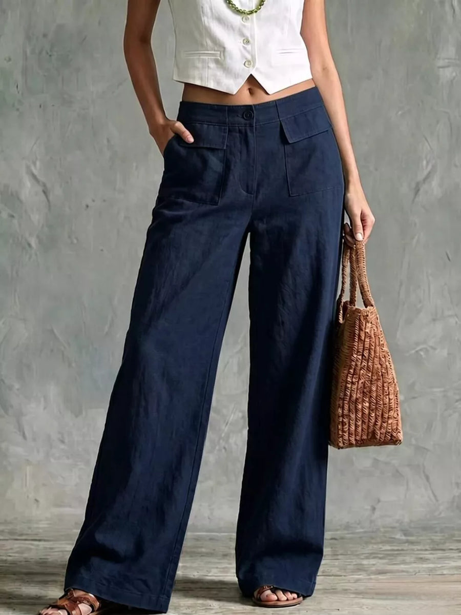 Navy linen wide-leg pants with flap pockets and a high waist.