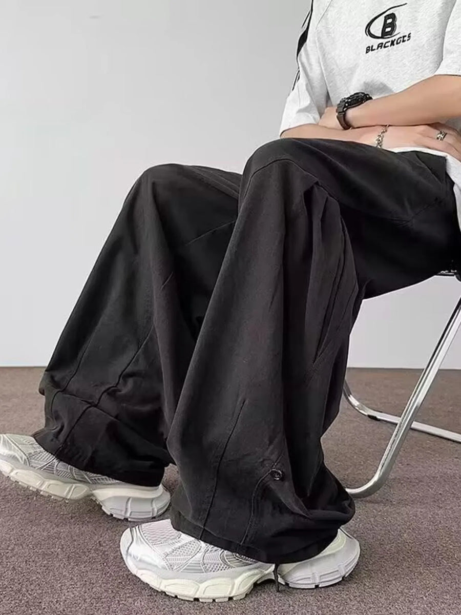 Black relaxed fit casual cargo pants with a comfortable fit and button detail.