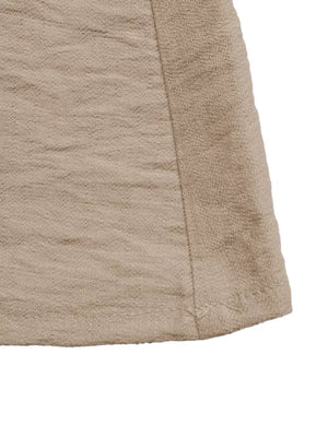 Textured beige maxi dress with elegant silhouette and subtle sheen.