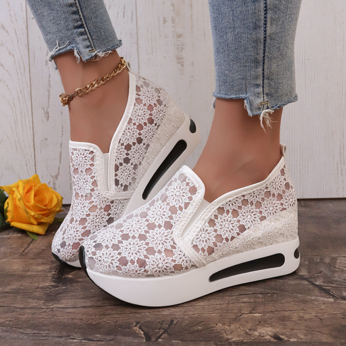 White floral lace slip-on sneakers with a chunky sole and breathable mesh detail.