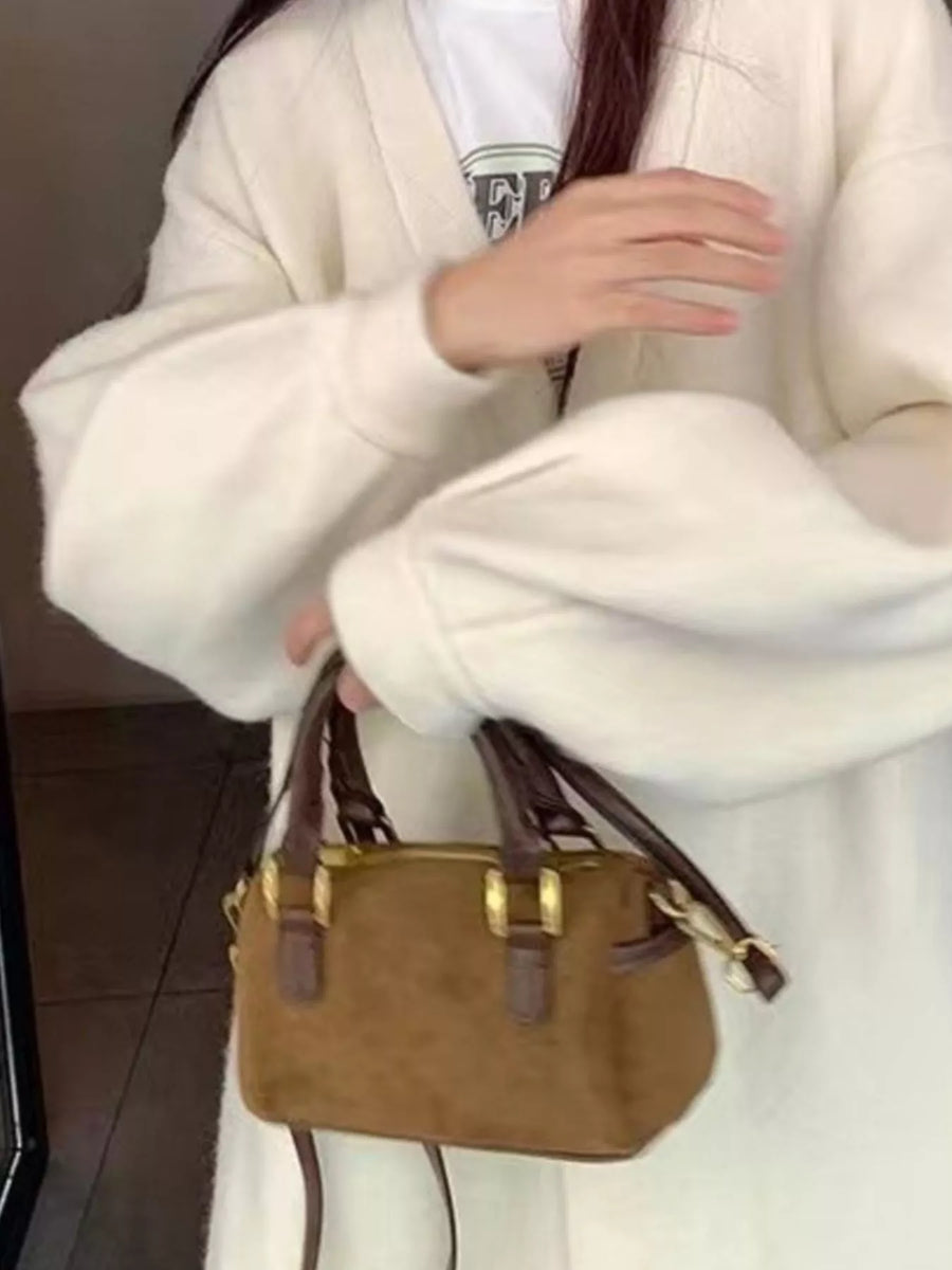 Vintage barrel crossbody bag in coffee brown suede with dark brown leather trim and gold hardware.