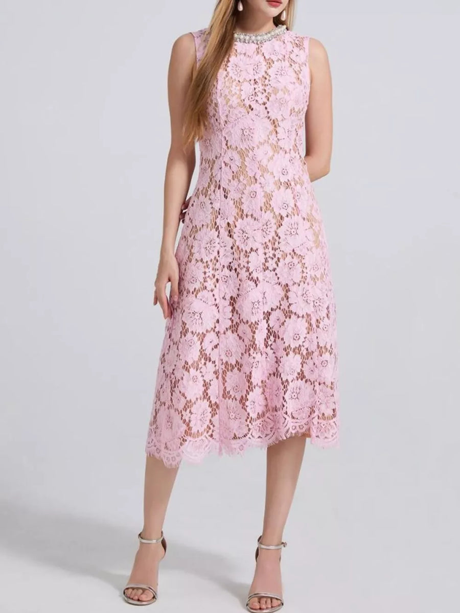 Pink lace dress with floral pattern, pearl neckline, and sleeveless design.