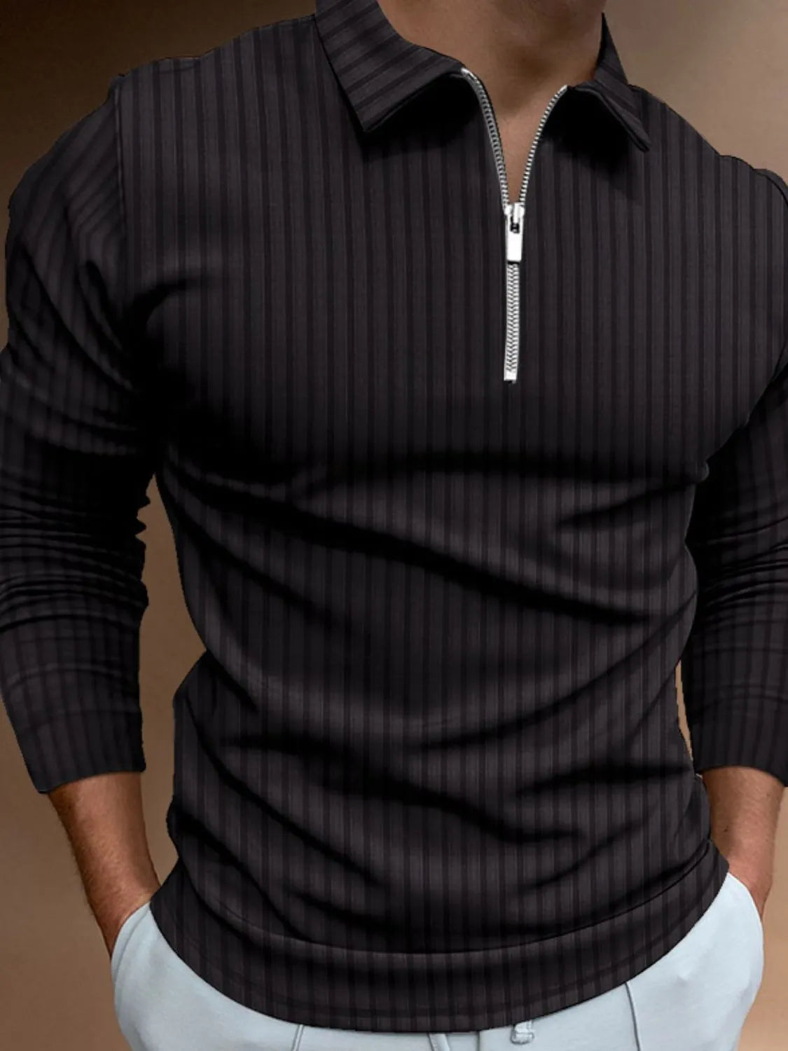 Black textured zip-neck polo with vertical stripes and long sleeves.
