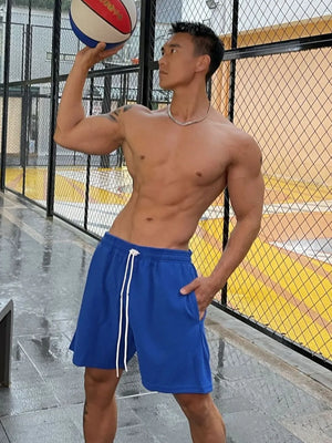 Royal blue athletic drawstring lounge shorts with white ties and pockets.