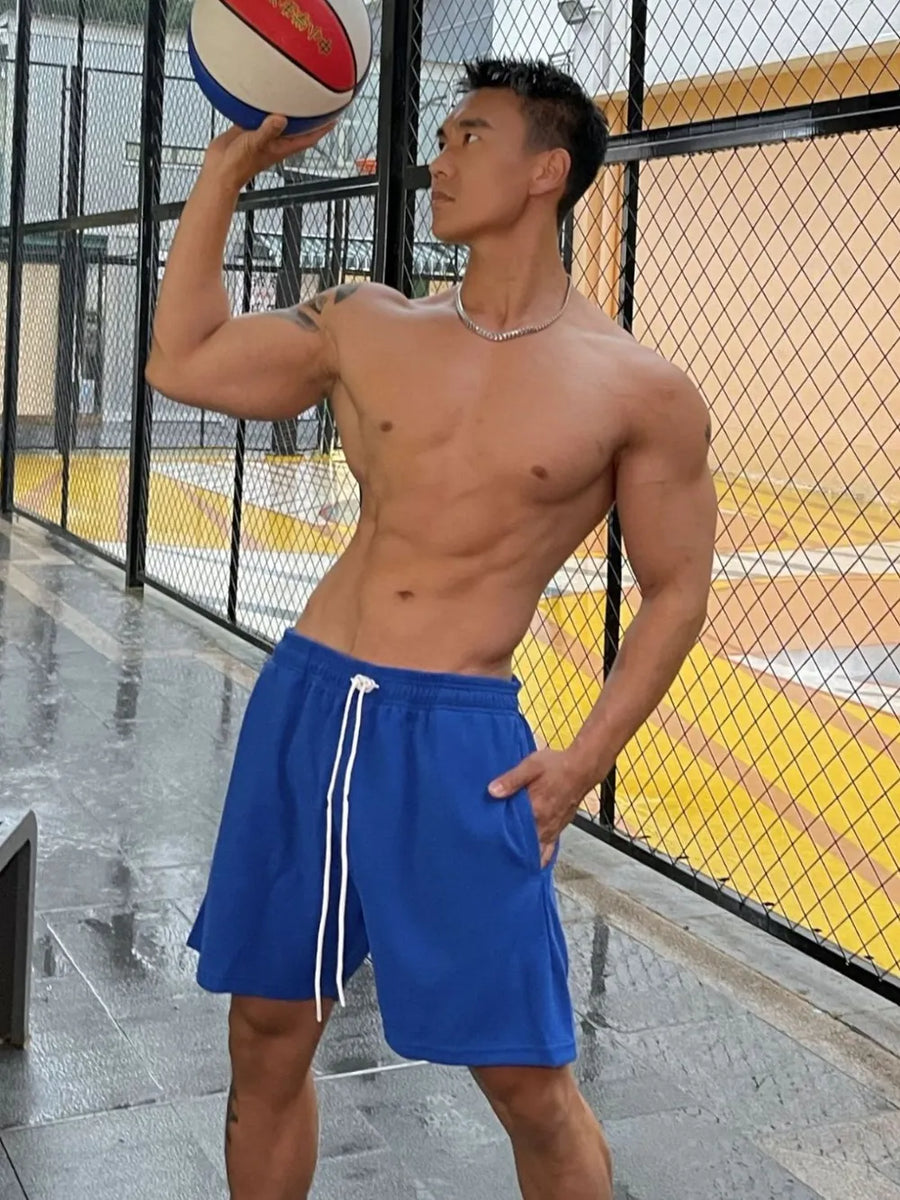 Royal blue athletic drawstring lounge shorts with white ties and pockets.
