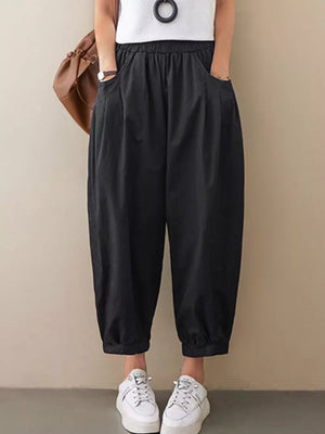 Black relaxed fit harem joggers with elastic waist and pockets.