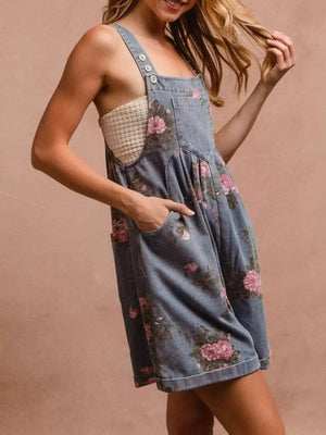 Denim overalls with floral print and pocket details.