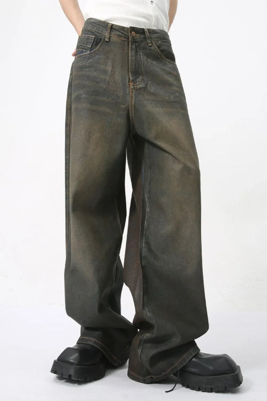 Faded oversized denim trousers in dark wash, featuring a relaxed fit and wide leg.