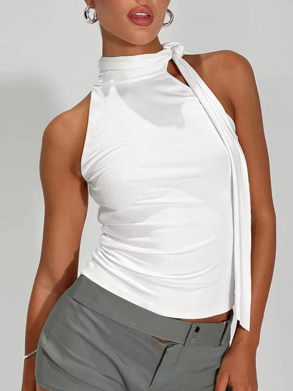 White halter top with draped detail and high neckline.