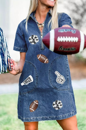 Denim mini dress in dark blue with football and cheer patches, short sleeves, and a zip neckline.
