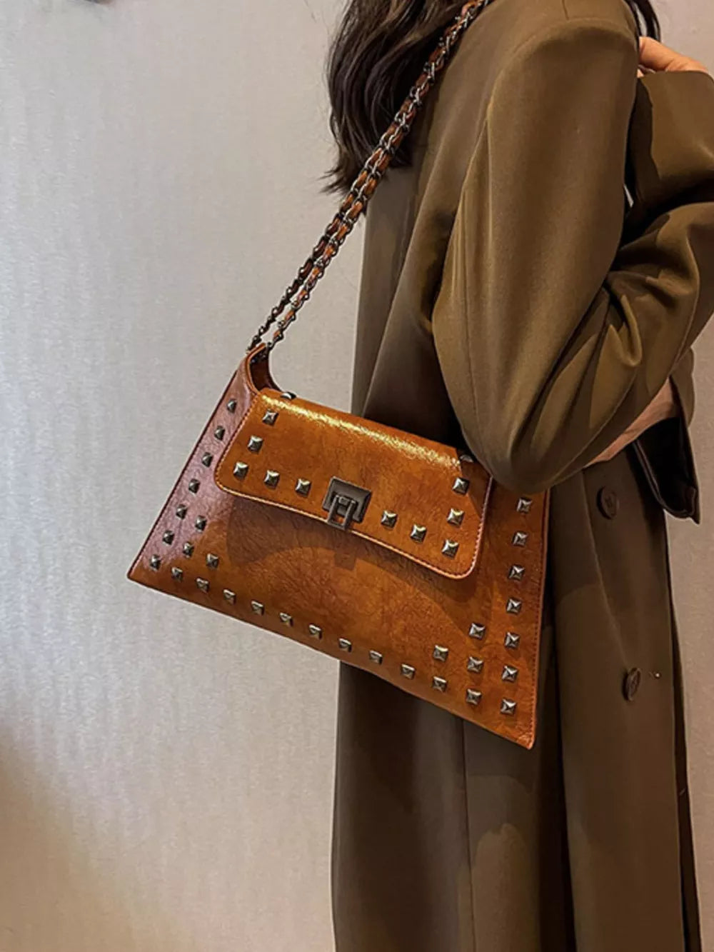Brown embellished chain flap shoulder bag with silver studs and a metal clasp.