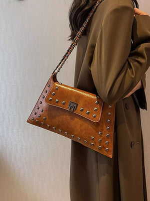 Brown embellished chain flap shoulder bag with silver studs and a metal clasp.