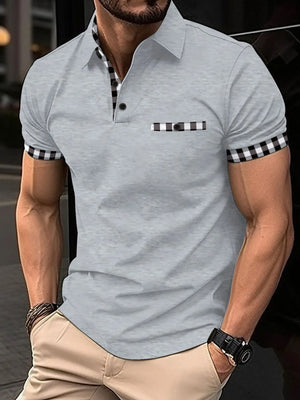 Gray polo shirt with checkered trim on collar, pocket, and sleeves