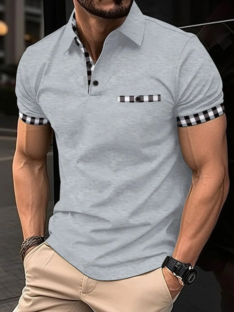 Gray polo shirt with checkered trim on collar, pocket, and sleeves