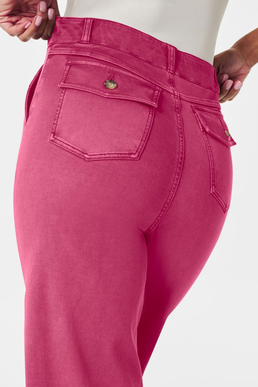 Fuchsia pink wide-leg utility denim trousers with buttoned flap back pockets.