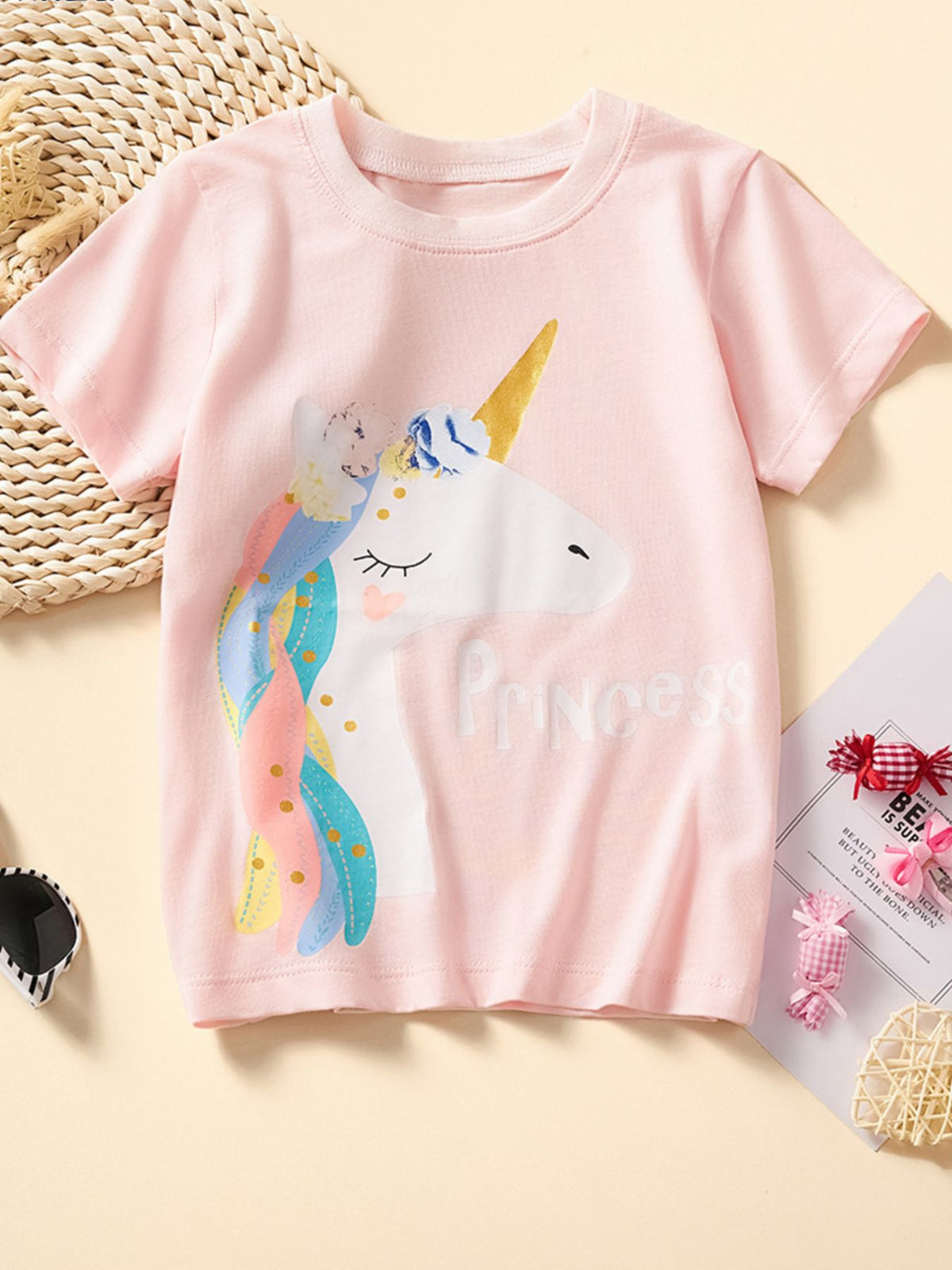 Blush pink cotton crew neck t-shirt with a unicorn graphic and "Princess" text.