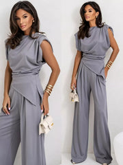 Gray satin cowl neck two-piece set with wide-leg pants and draped top.