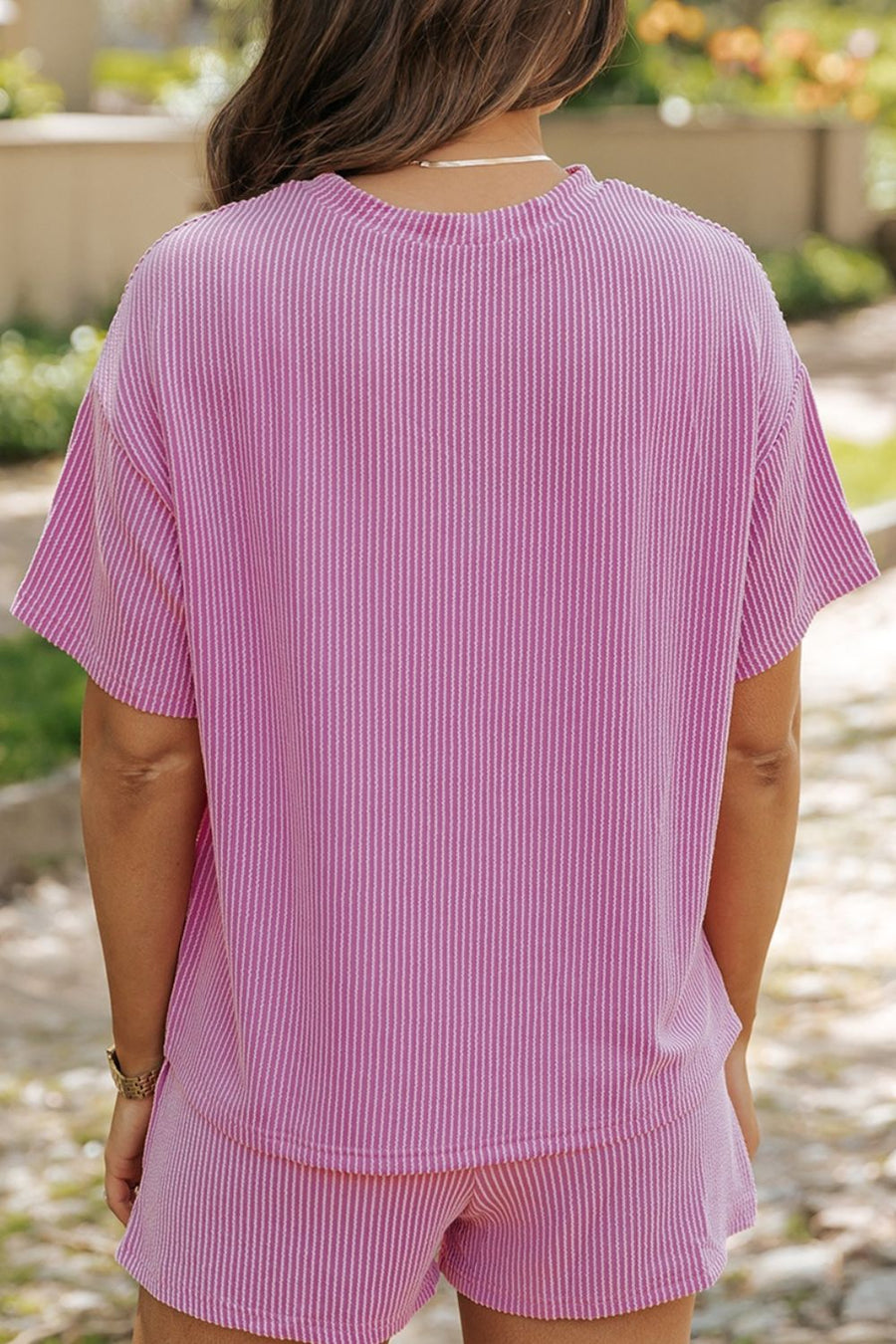 Pink striped loungewear set with short sleeves and shorts.