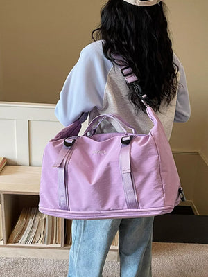 Spacious purple nylon travel bag with adjustable buckle straps and crinkled texture.