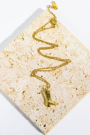 Gold cowboy boot charm necklace with intricate detailing on a delicate chain.