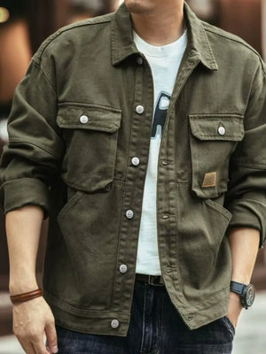 Moss green washed cotton chore jacket with four front pockets and button closure.