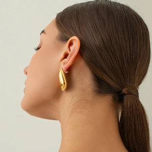 Sculpted gold vermeil oval hoop earrings with beaded edge detail.
