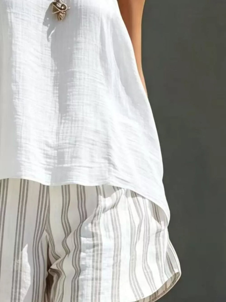 White textured tank top with striped linen shorts.
