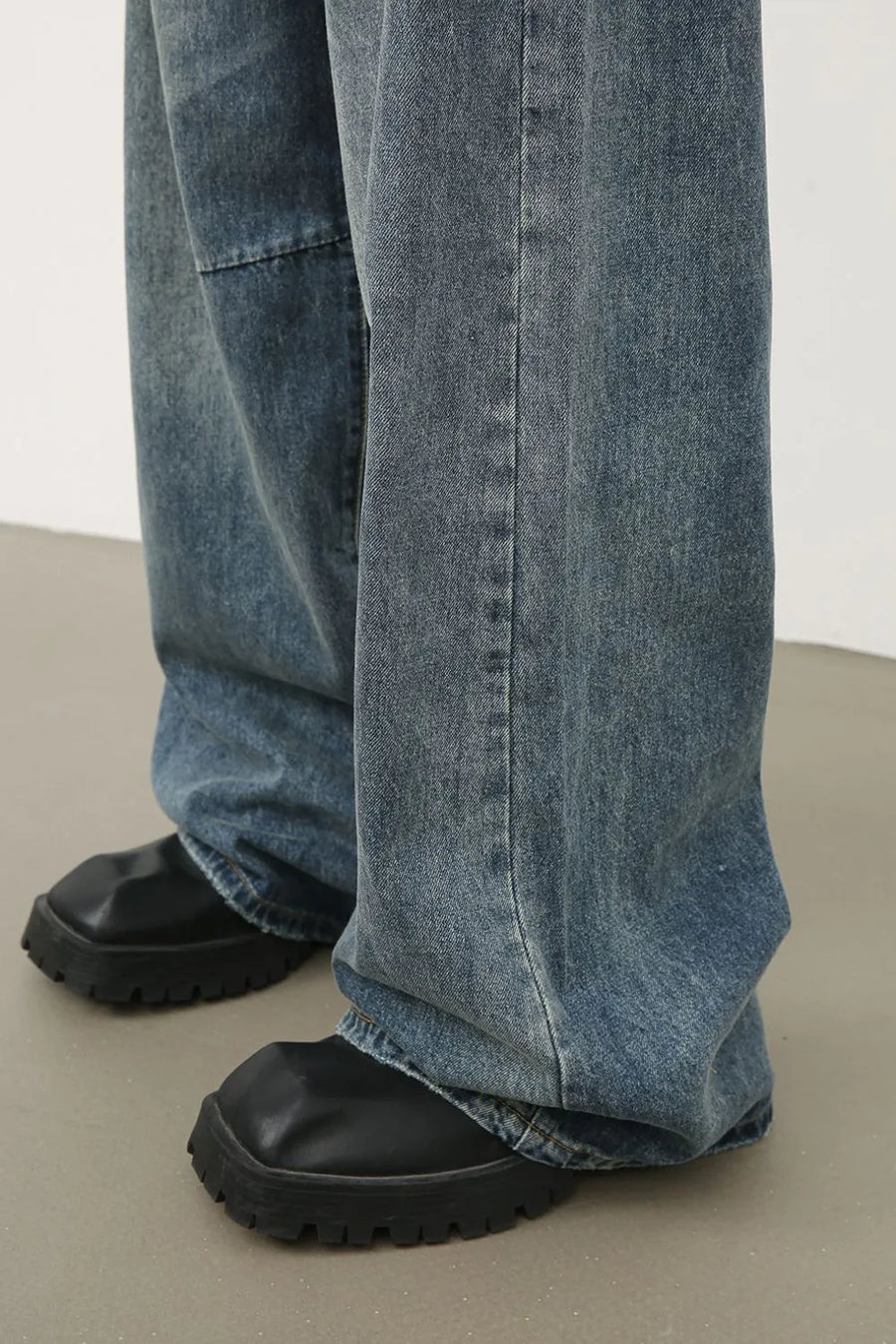 Distressed edge wide-leg denim jeans in medium wash, showing a relaxed fit and casual styling.