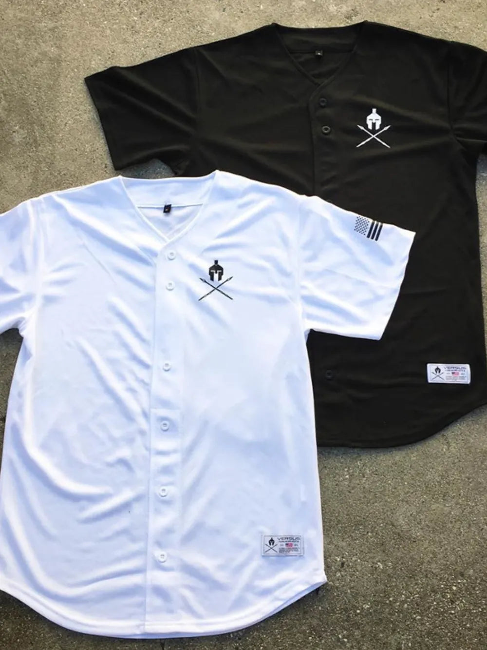 White and black baseball jerseys with graphic detail and button front.