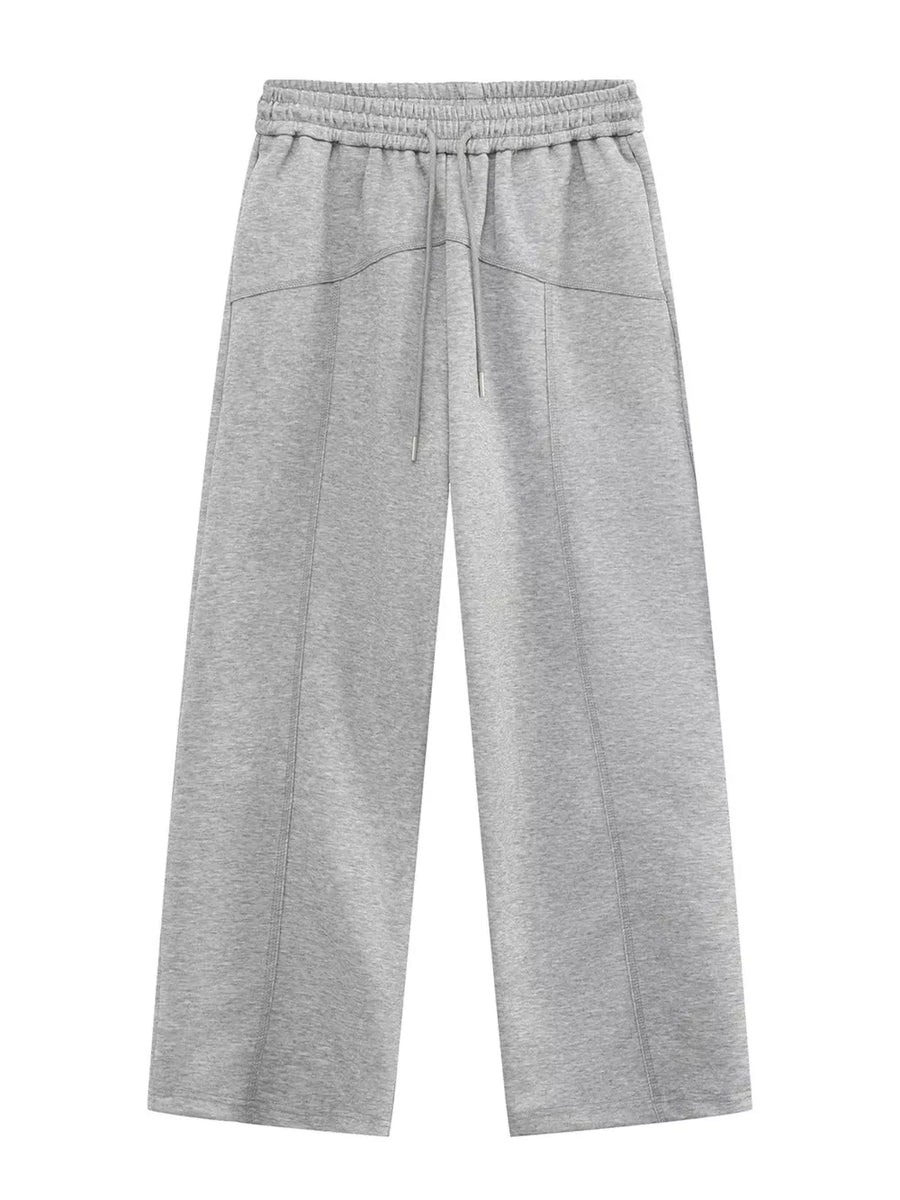 Gray cotton drawstring sweatpants with wide legs and seam details.