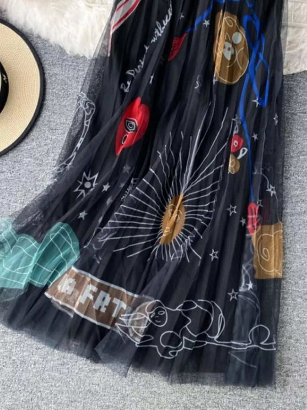 Black tulle skirt with whimsical sunburst and abstract print, midi length